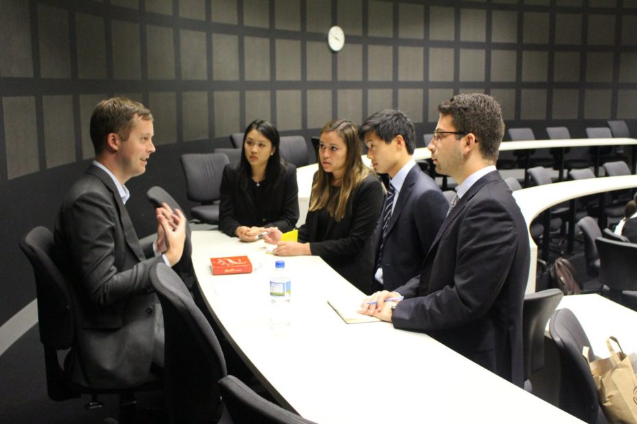 Prof. Keith Niedermeier meeting with his case team at the competition.