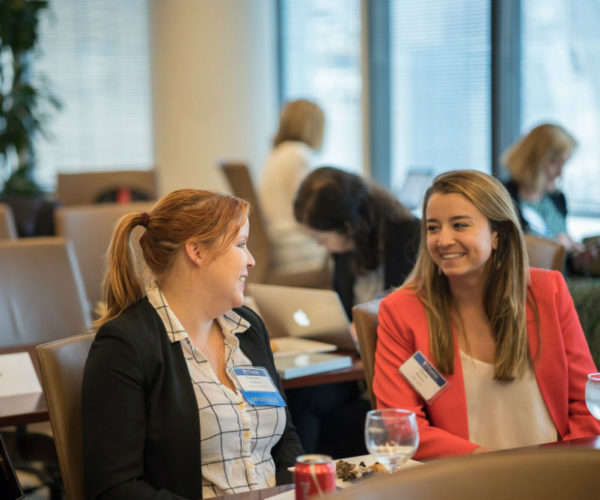 Katherine DeBerry of Prudential Financial speaking with a journalist attending the Wharton Seminars for Business Journalists at Morgan, Lewis & Bockius LLP on June 13, 2018 in New York.