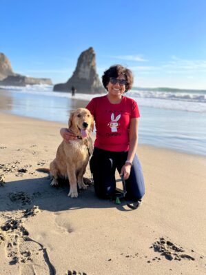 Priyanka Vergadia with her dog on the beach