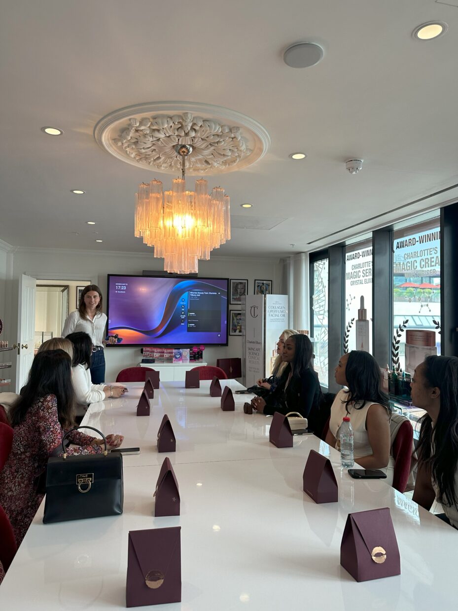 Students listening to a presentation at Charlotte Tilbury headquarters.