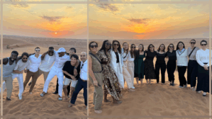 Lauder Intercultural Venture (LIV) travel participants smile and stand side by side on a beach with the sunset in the background.